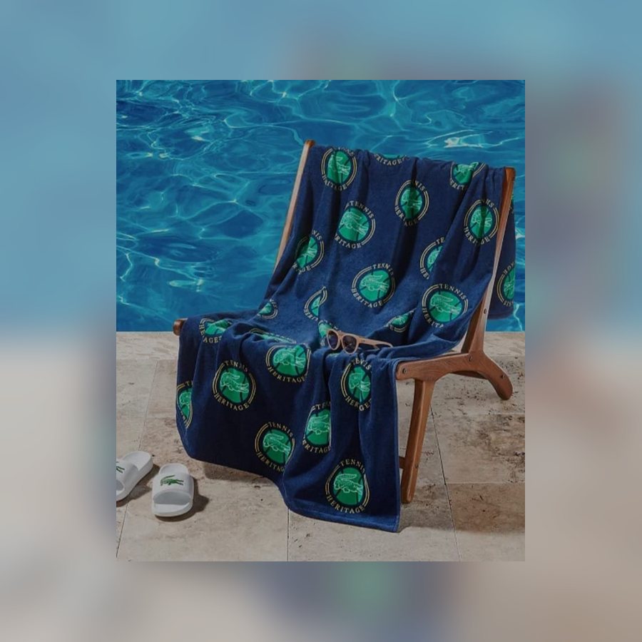 Navy Lacoste tennis beach towel on a pool chair