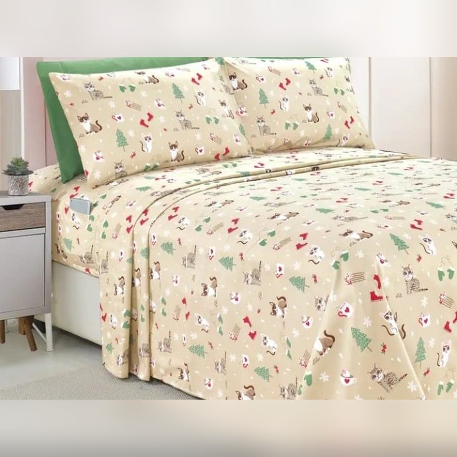 Cream bed sheet set with a cat and Christmas print on a bed