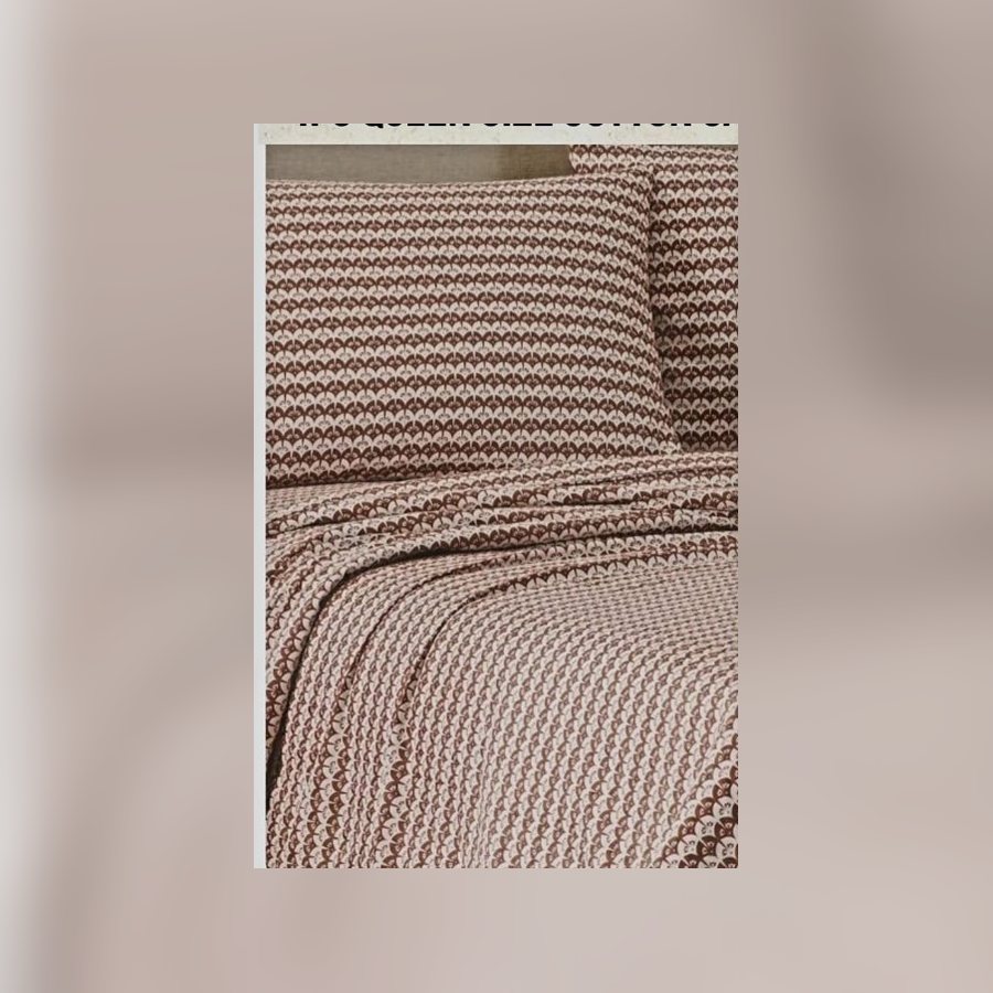 Brown and white patterned sheet set on a bed