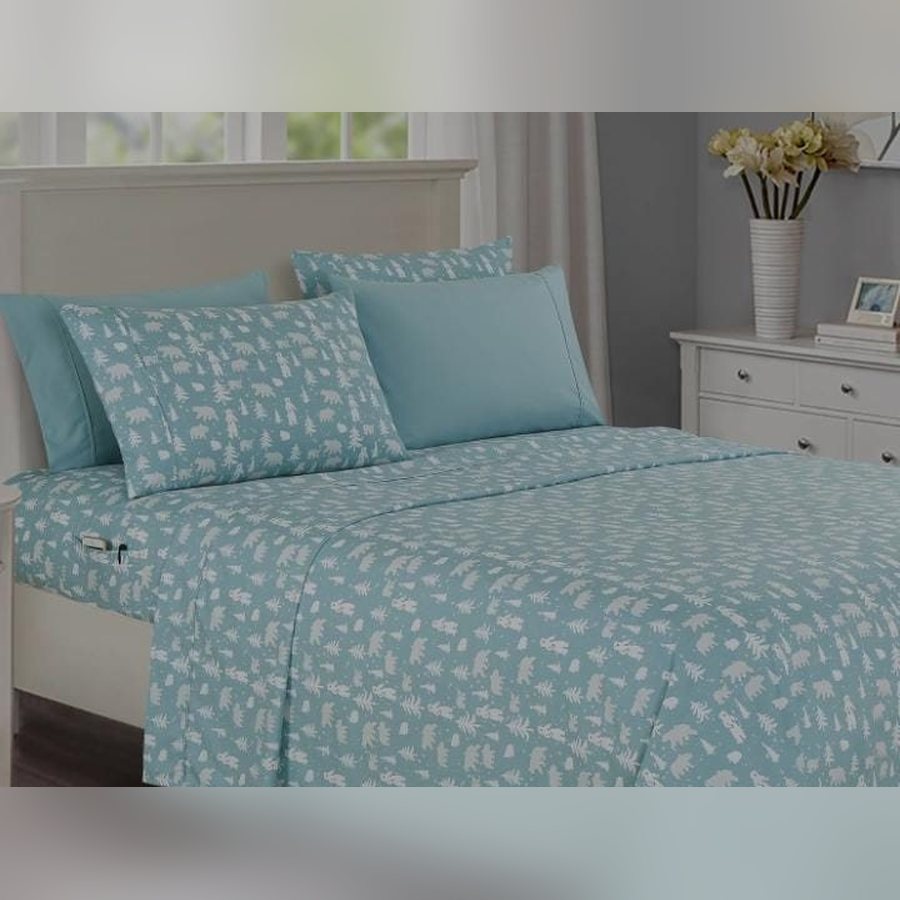 Light blue polar bear print sheet set on a bed