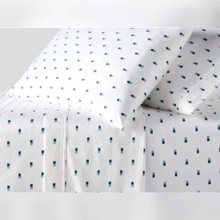 White sheet set with a small teal dot print
